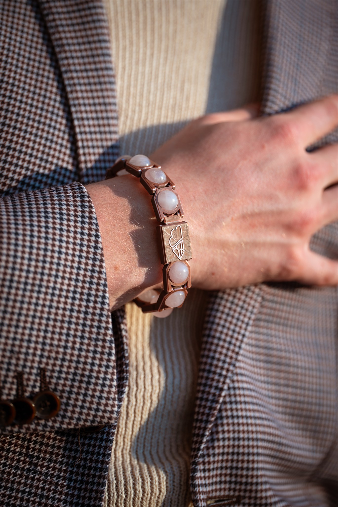 Rose-quartz Crystal Sky bracelet styled with a tailored jacket