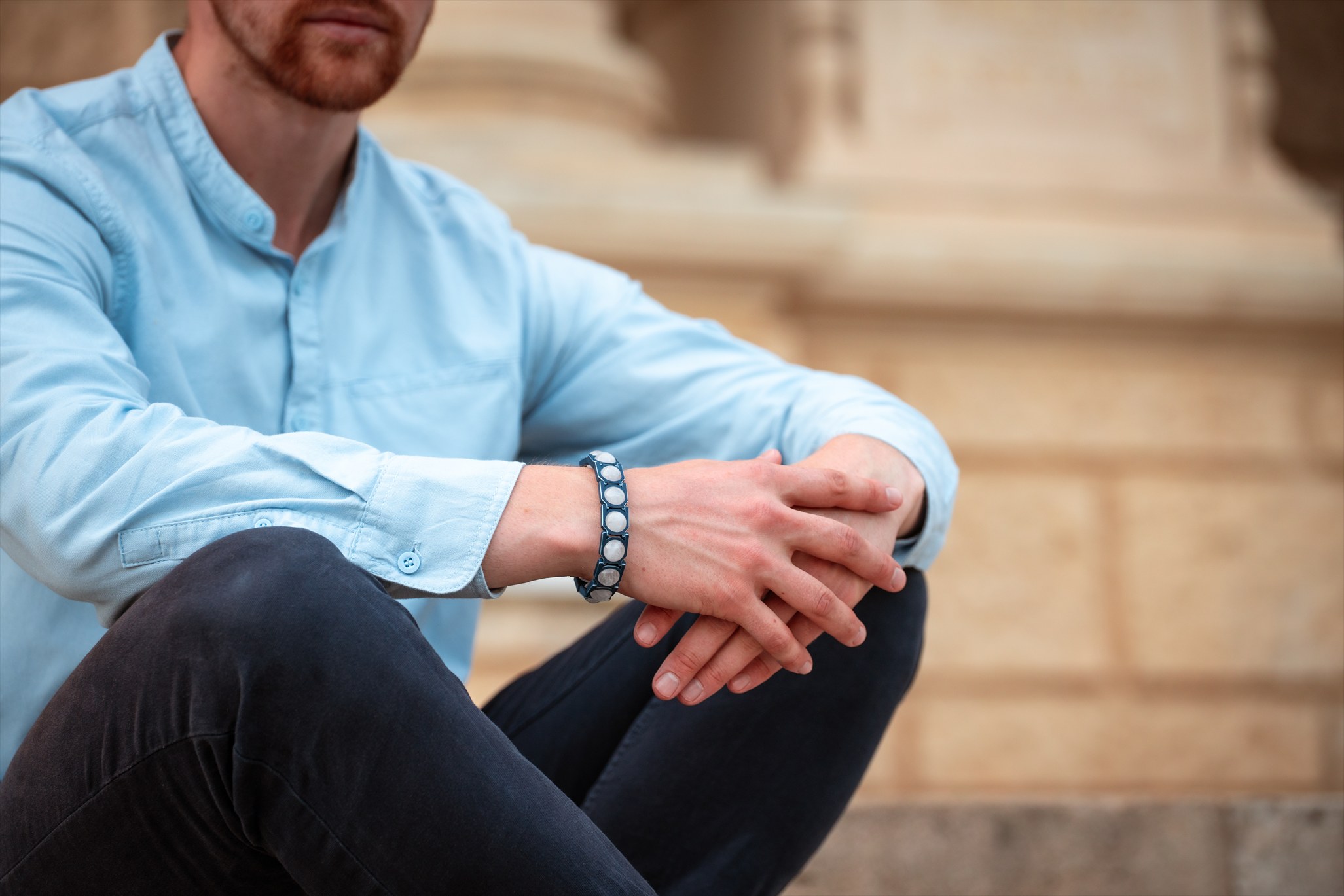 Clear-stone Crystal Sky bracelet worn with a blue shirt