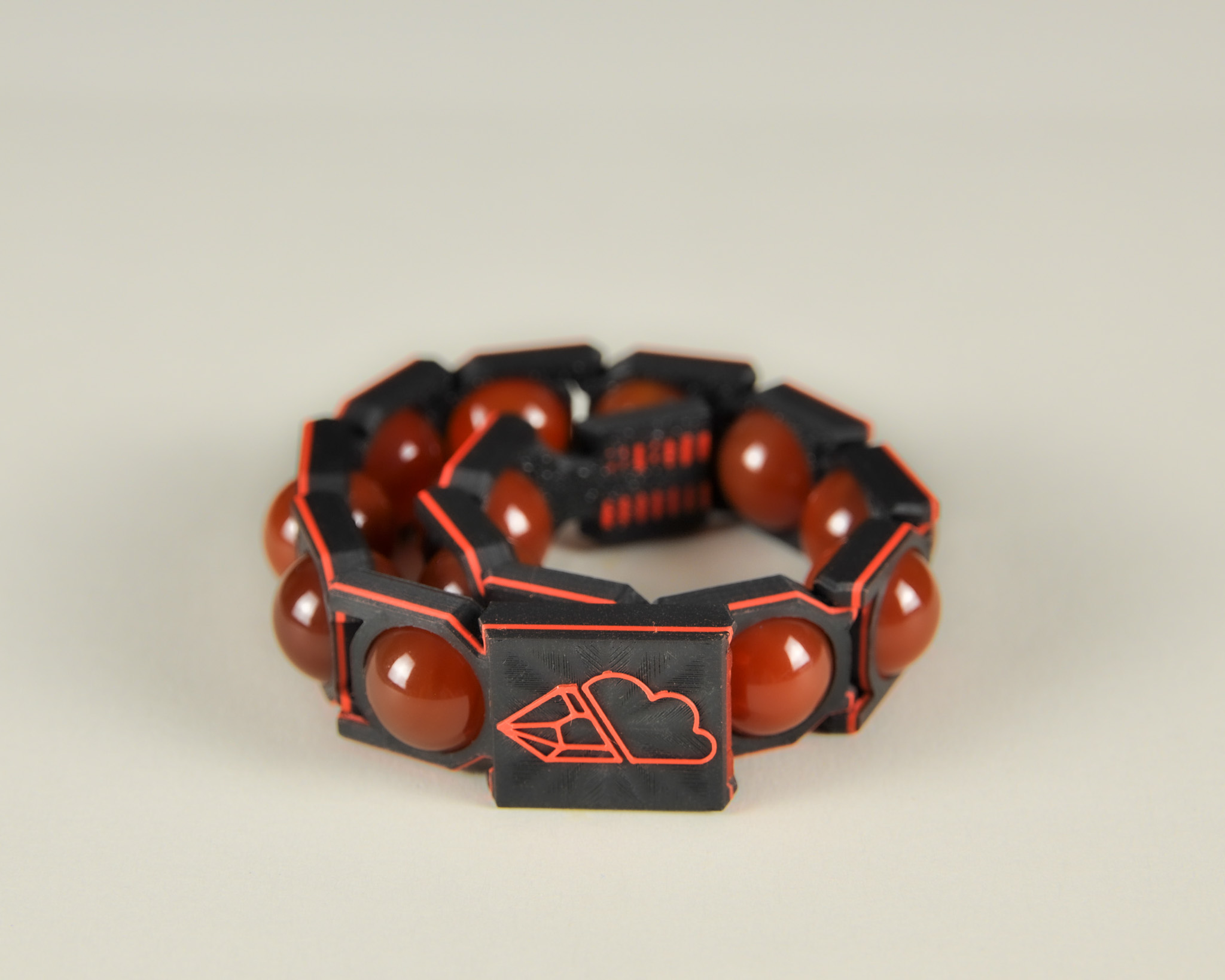 Red agate bracelet in red and black, angled view