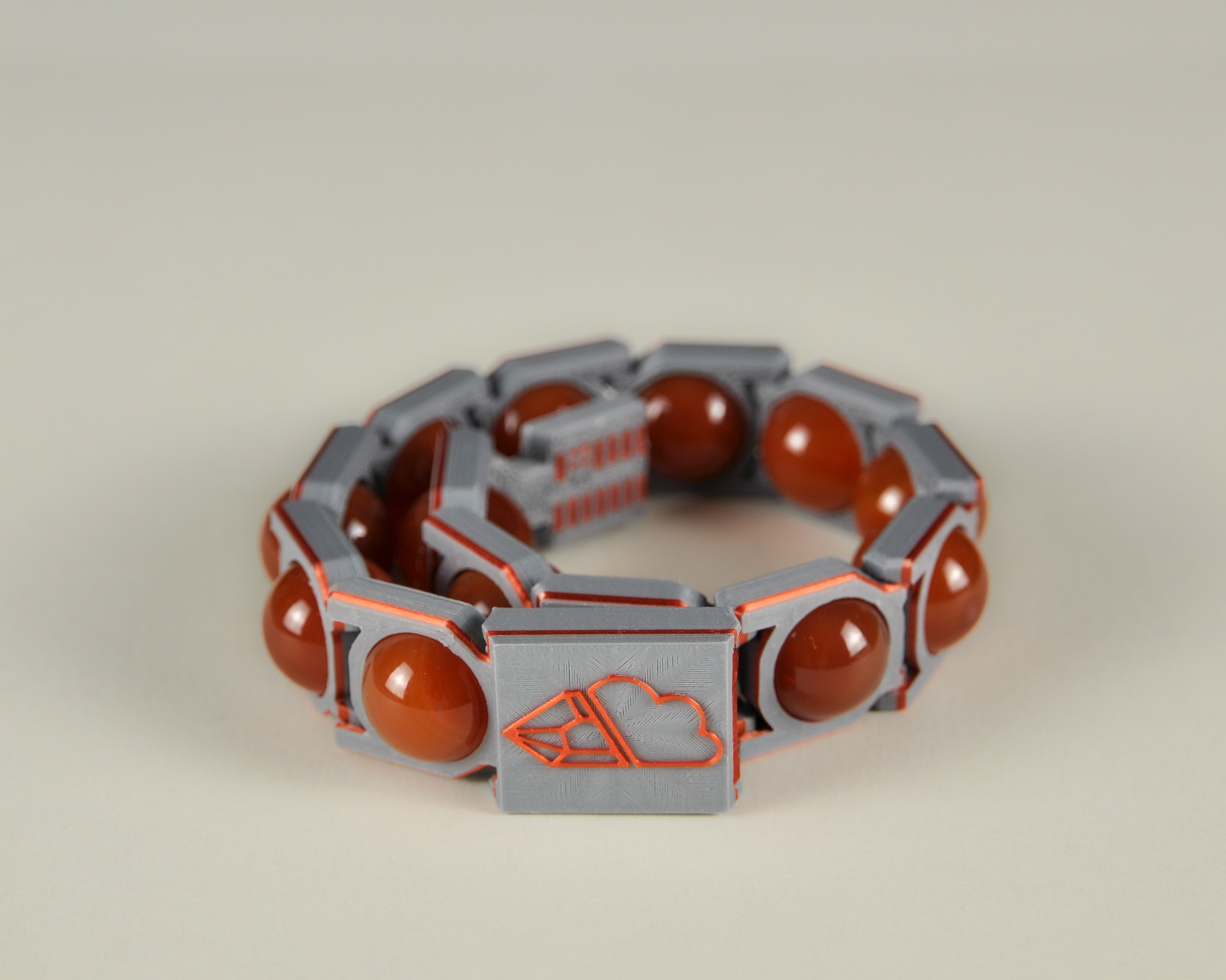 Red agate bracelet in red and grey, angled view