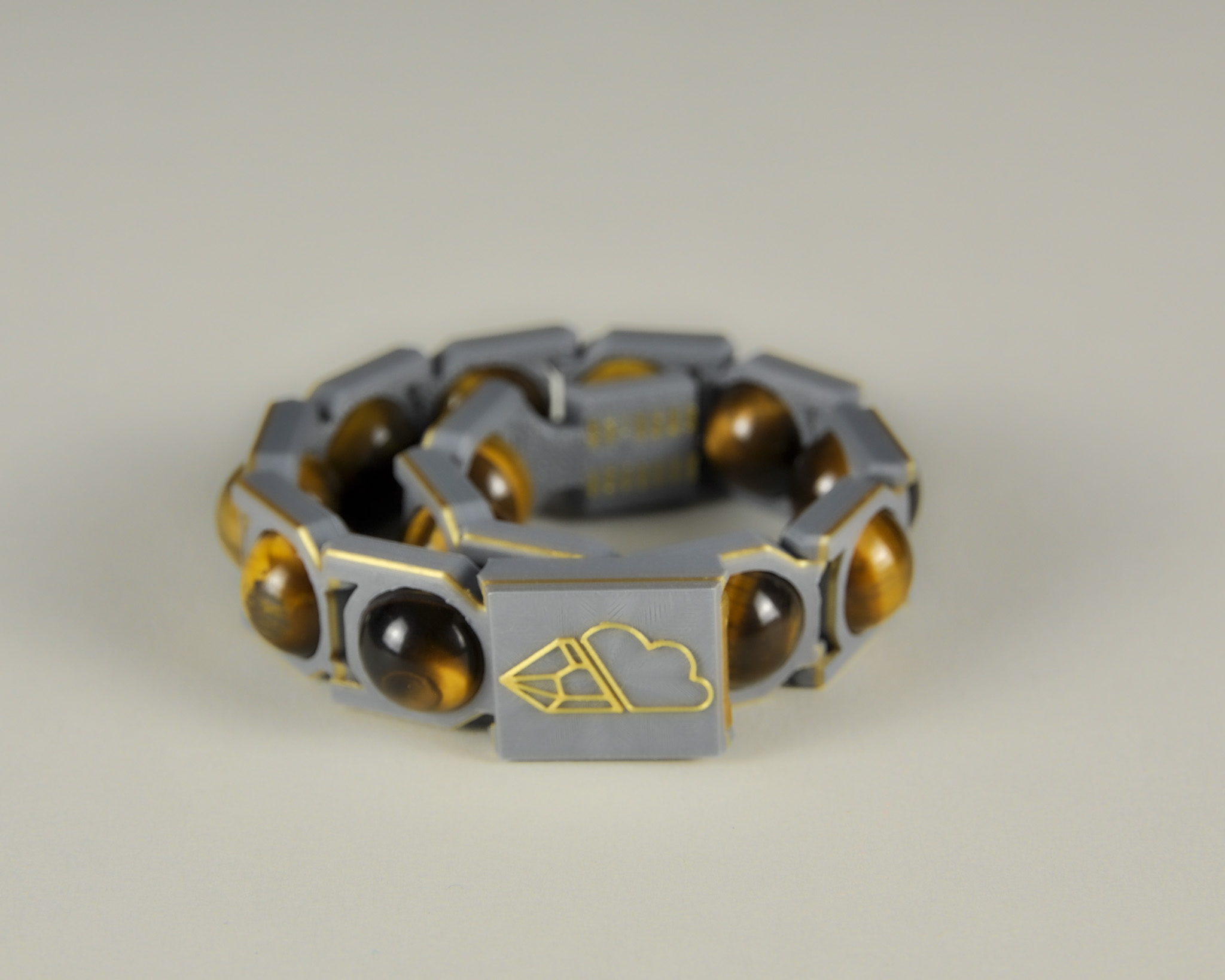 Tiger’s eye bracelet in gold and grey, angled view